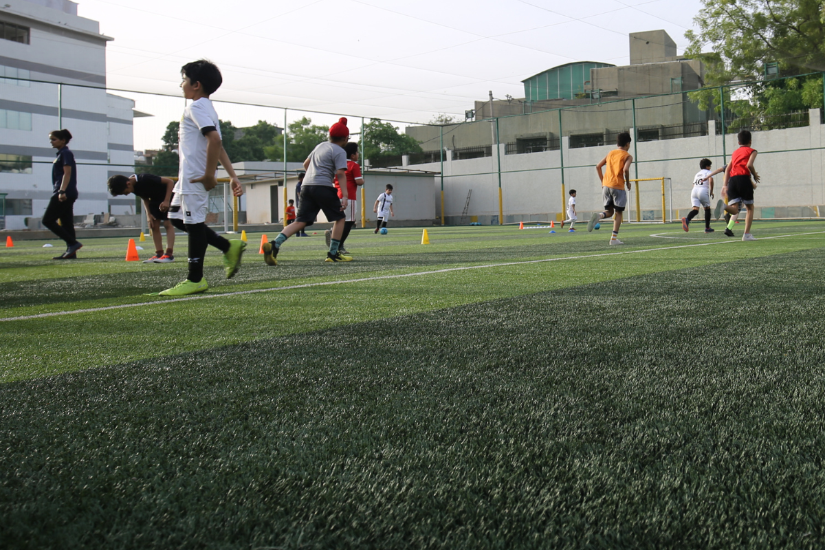 Children playing on the football turf in Vikaspuri.
